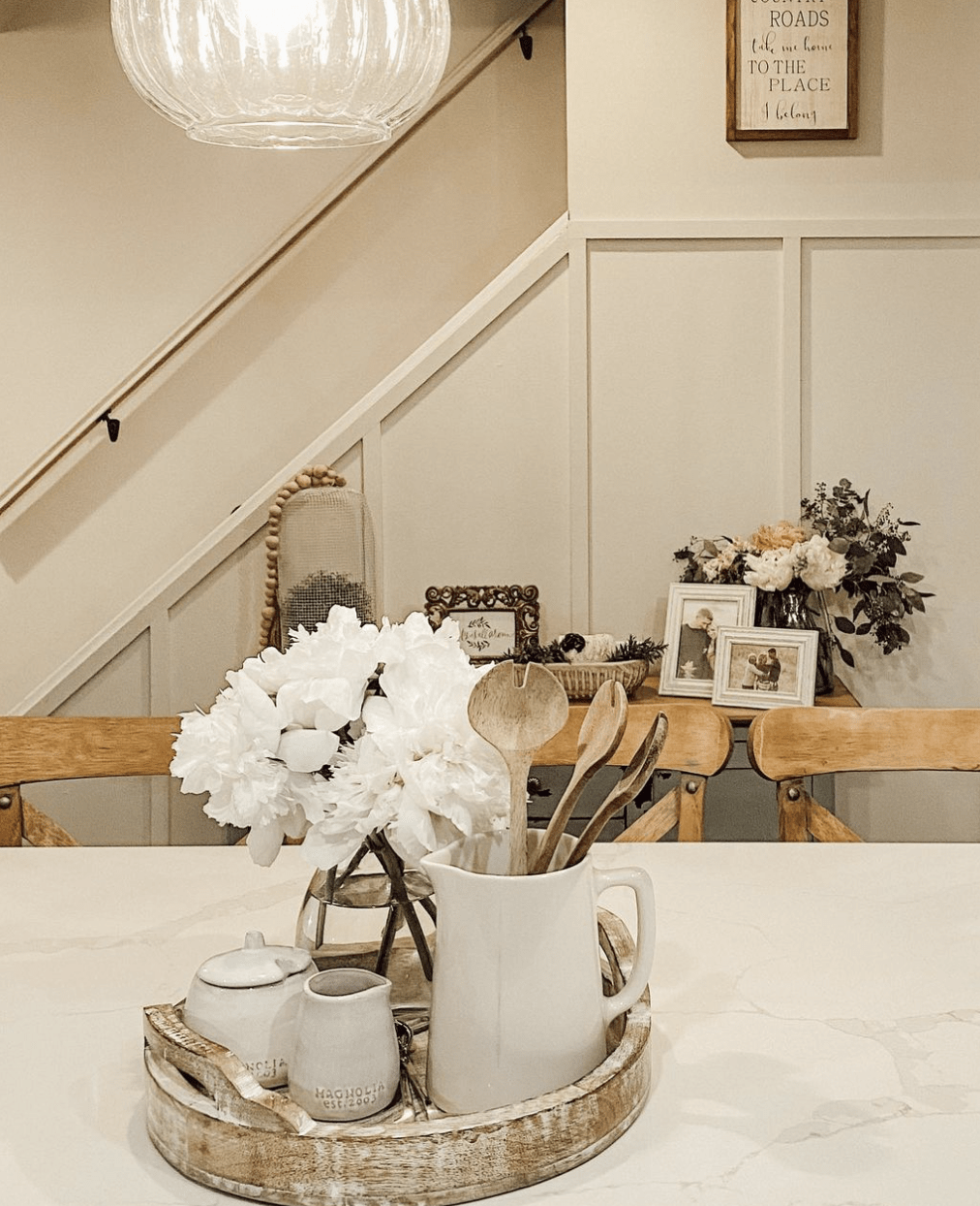 marble countertop decorated with wood tray and flower arrangement