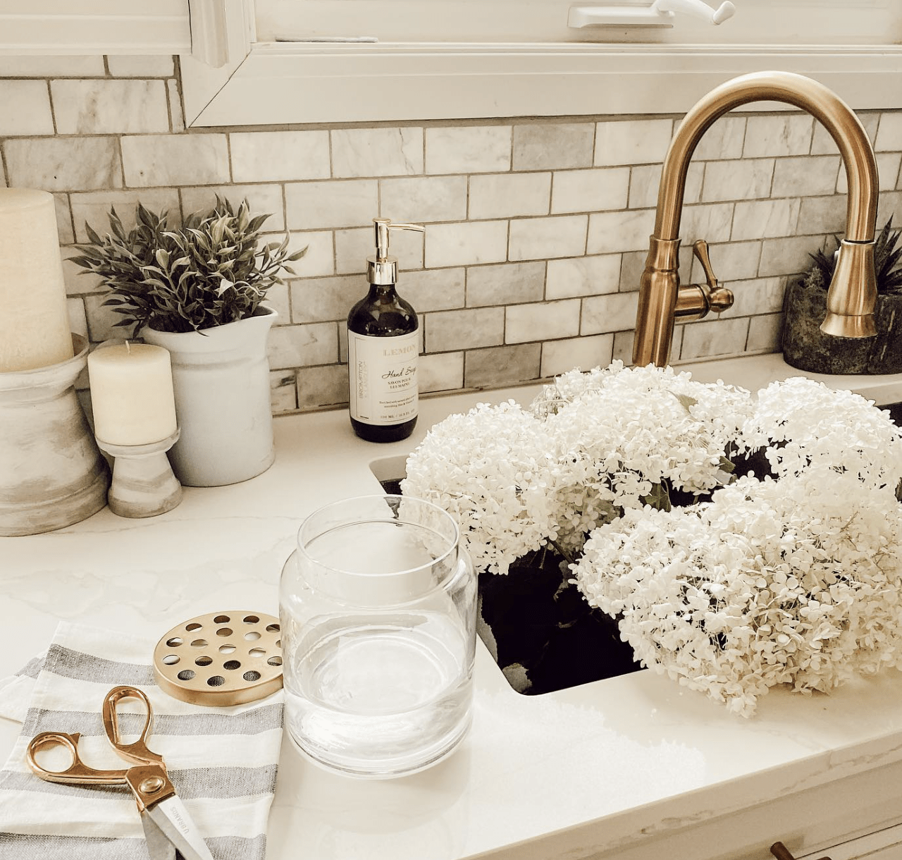 sink full of flowers gold faucet marble countertops