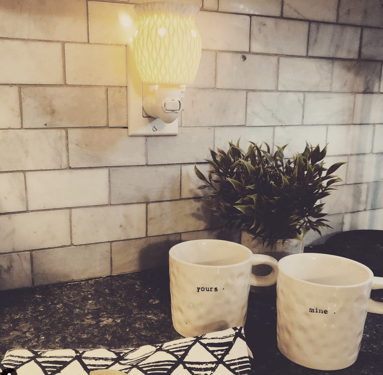 set of mug on black countertop with plug in scentsy