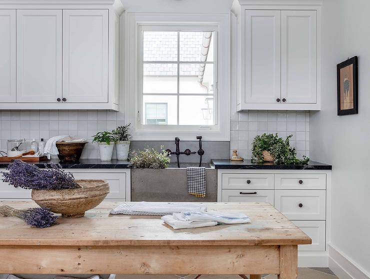 White cottage kitchen boasts a freestanding farmhouse island.