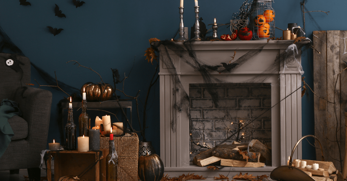 Dark living room mantel with halloween decoration around it.