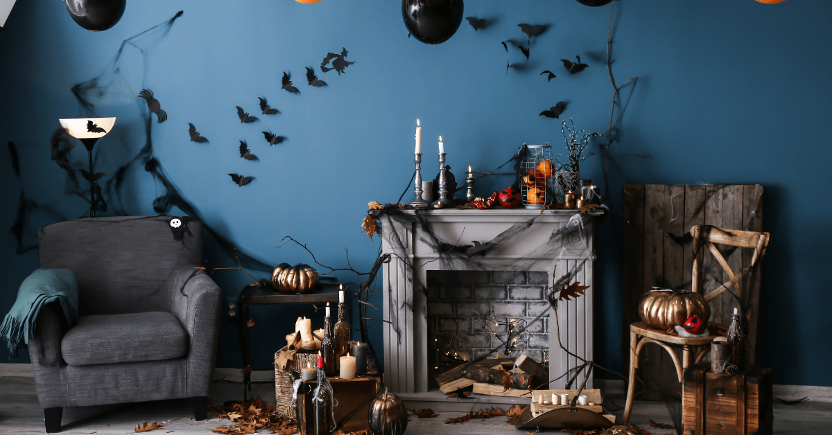 A dark mantel in living room surrounded by halloween decoration.