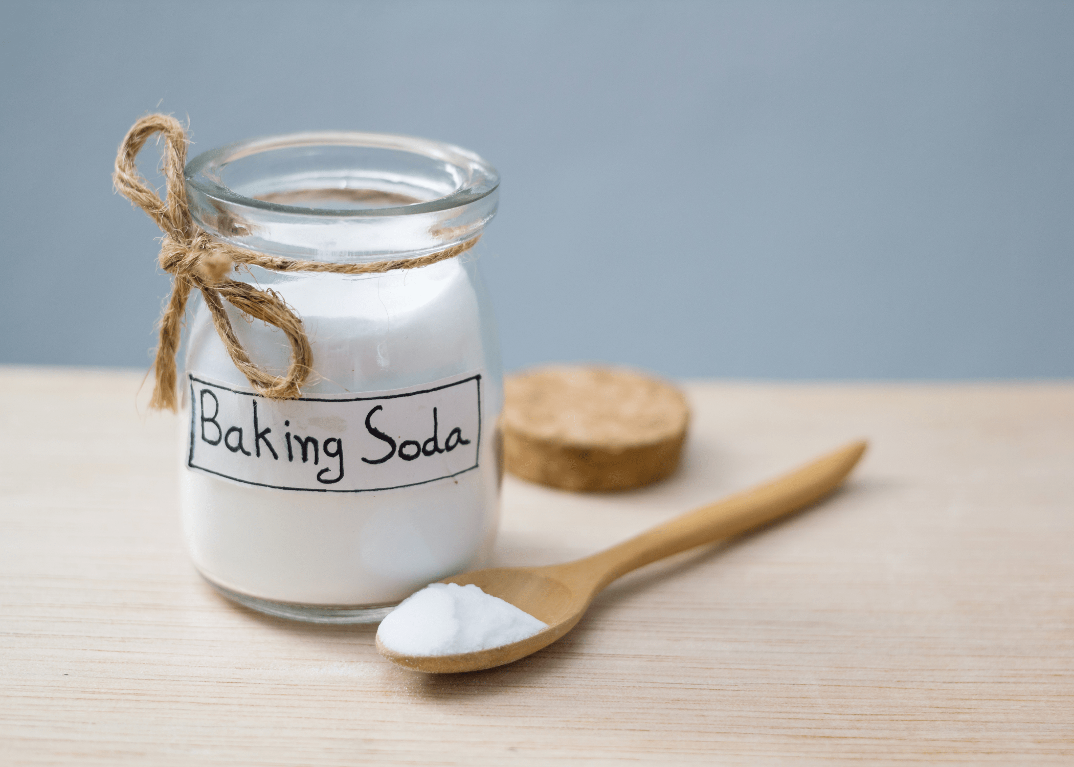 baking soda in labeled jar with wooden spoon