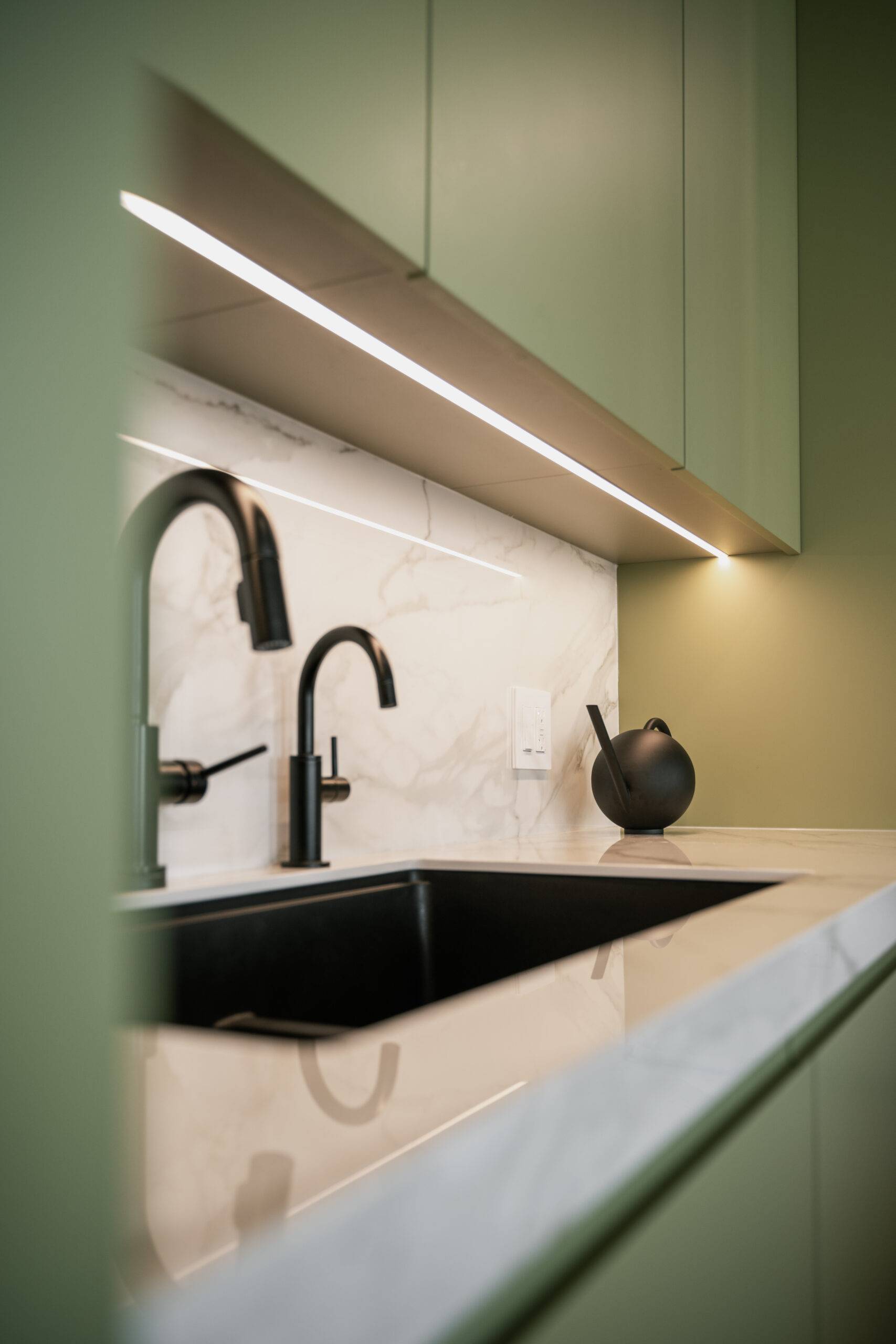 Sink with LED lighting and marble counter.