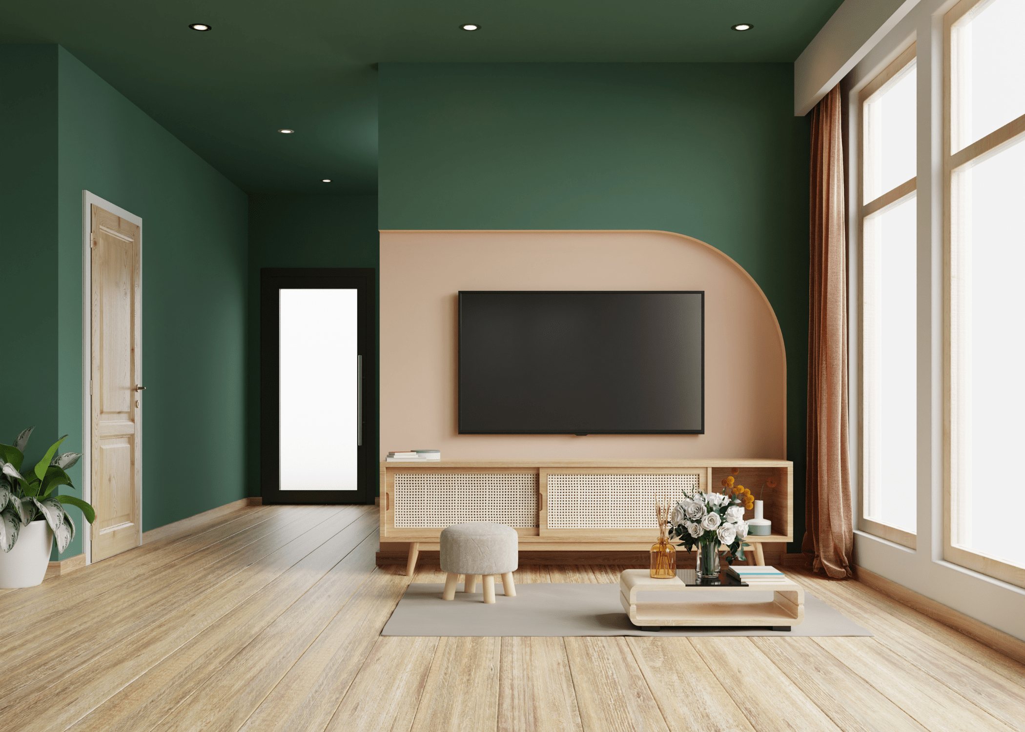 A green living room with wooden floors and natural colored furniture