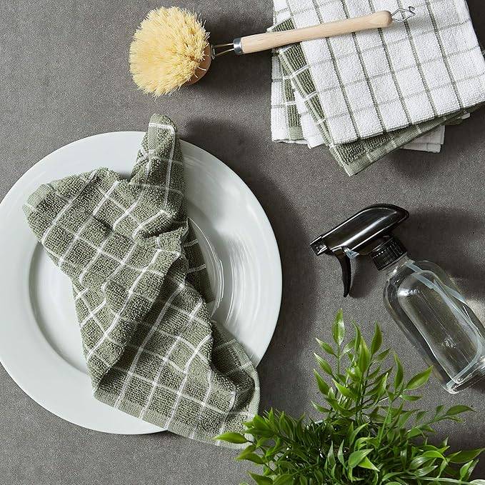 dish towels on plate with spray bottle and scrub brush