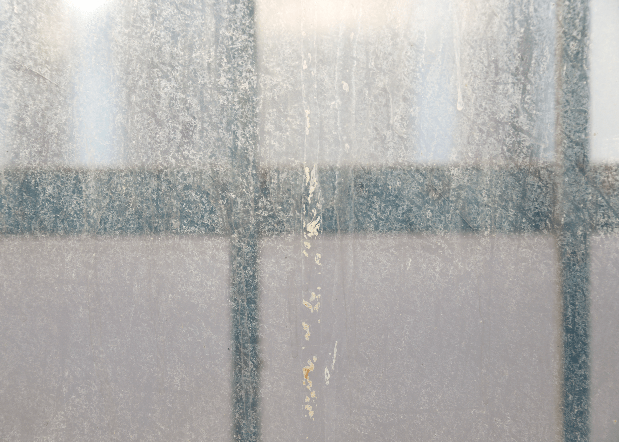 close up of hard water on shower glass