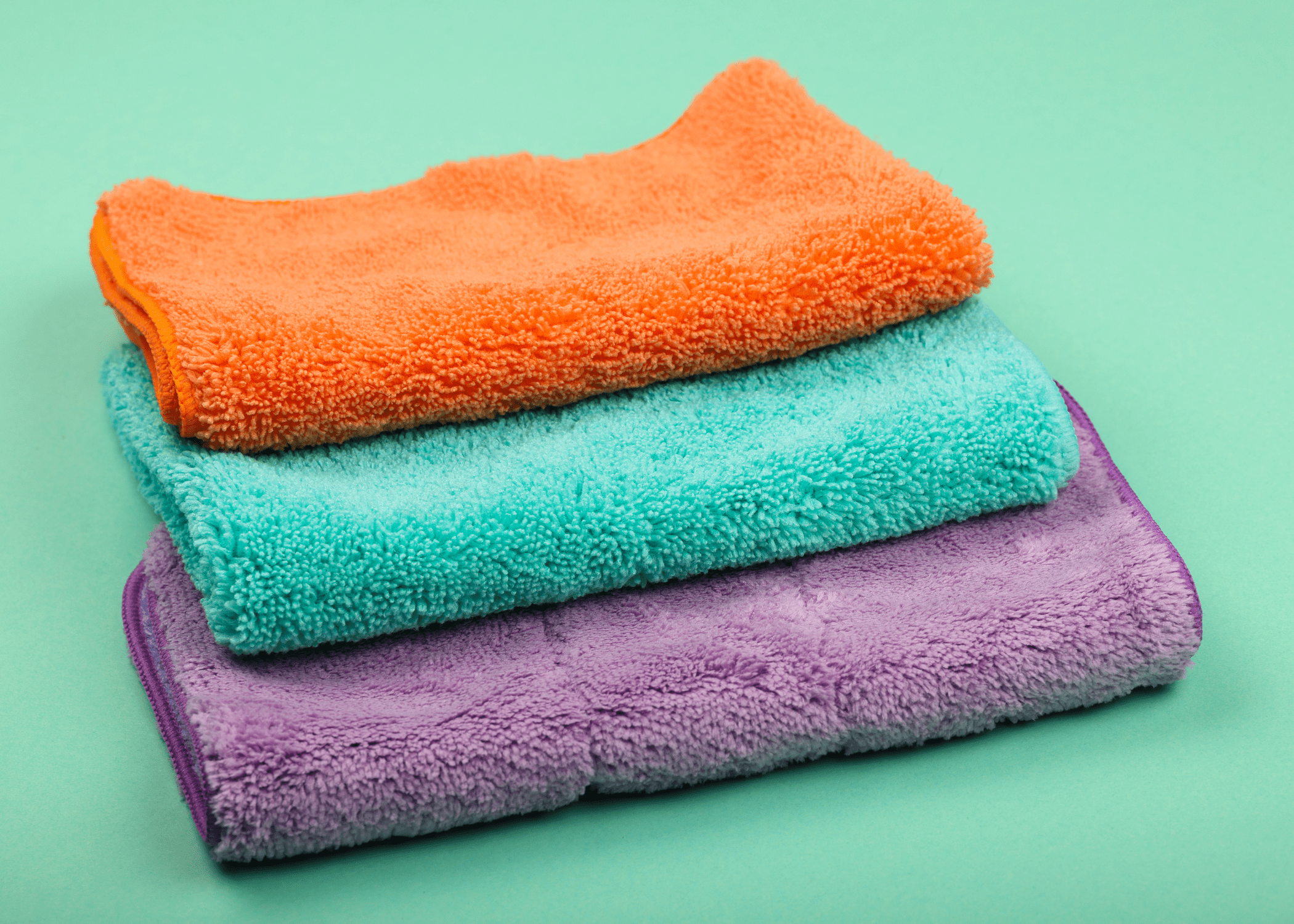 stack on colored microfibre cloths on light green background