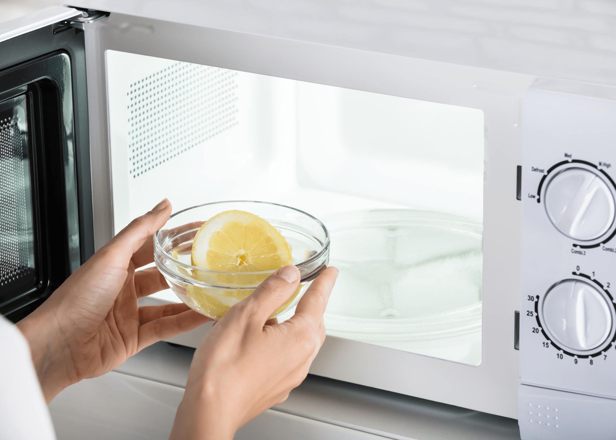 lemon in water being placed into microwave