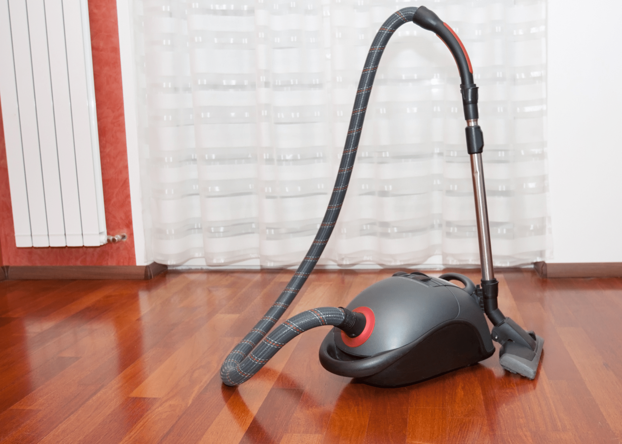 vacuum with long arm in empty room