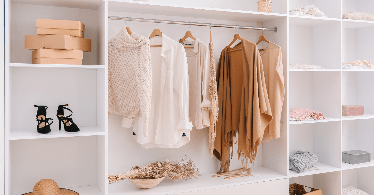 Seasonal-colored clothes in a closet.