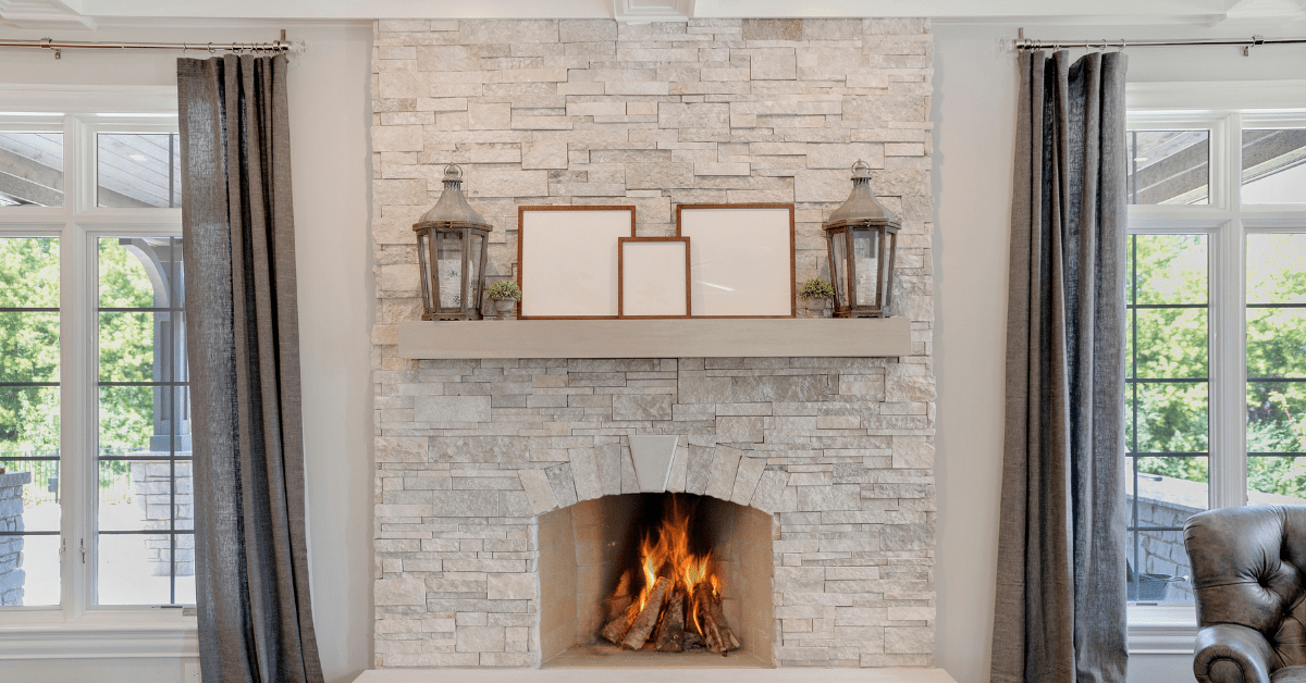 A white washed floor to ceiling stone fireplace.