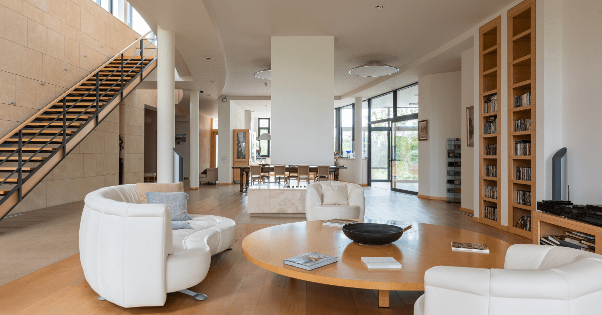 Living room with a ceiling to floor bookshelf.