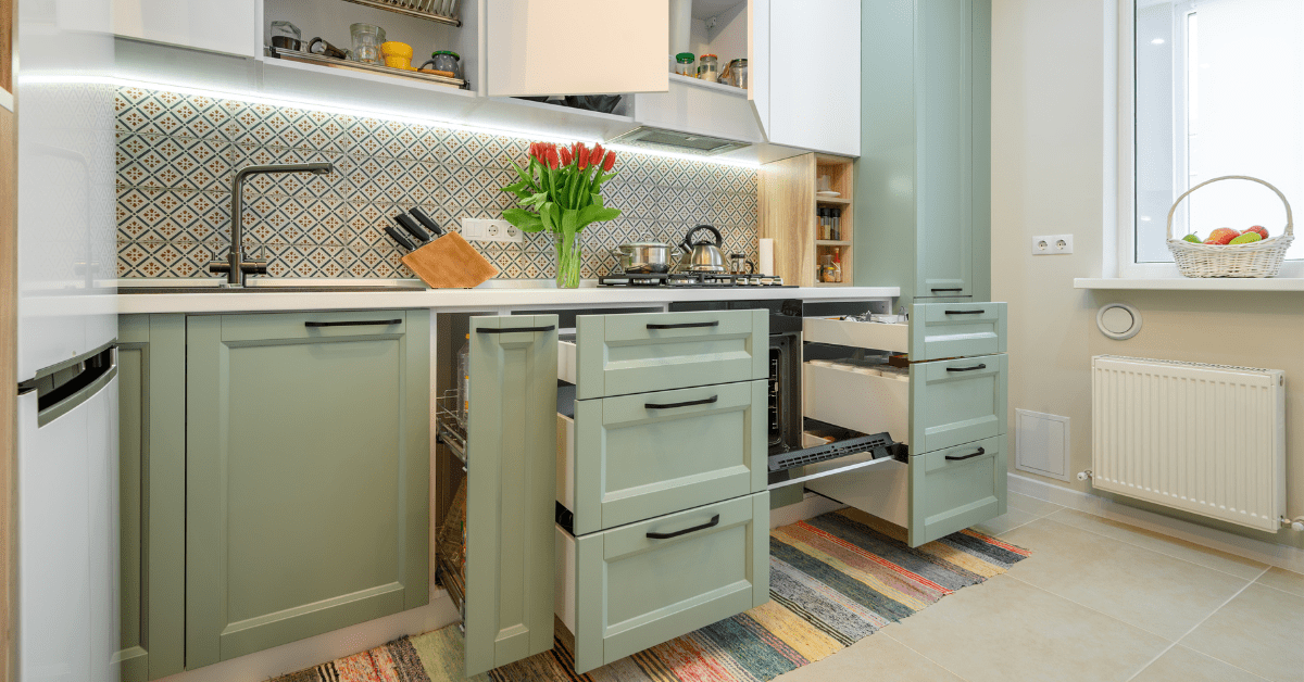 Pull out cabinets in sage green.