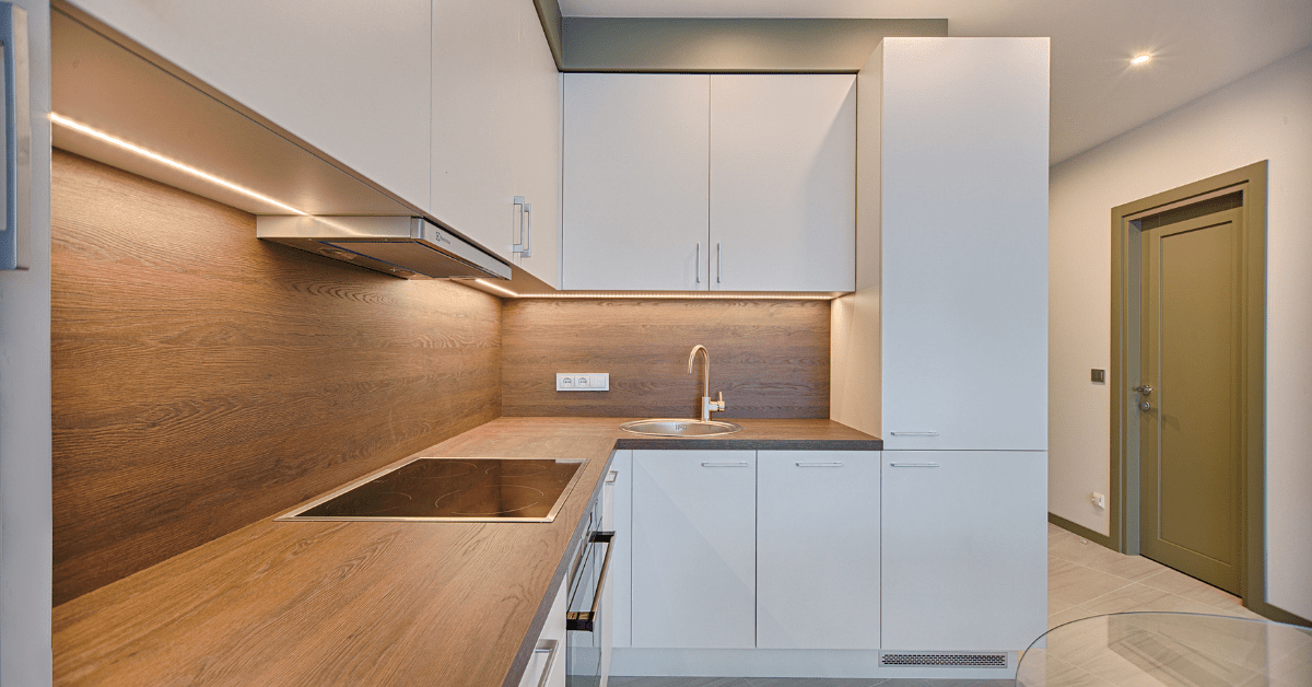 Sleek modern kitchen with wooden countertops.