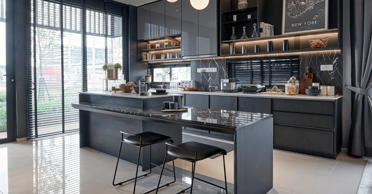 Dark kitchen with stools for seating.