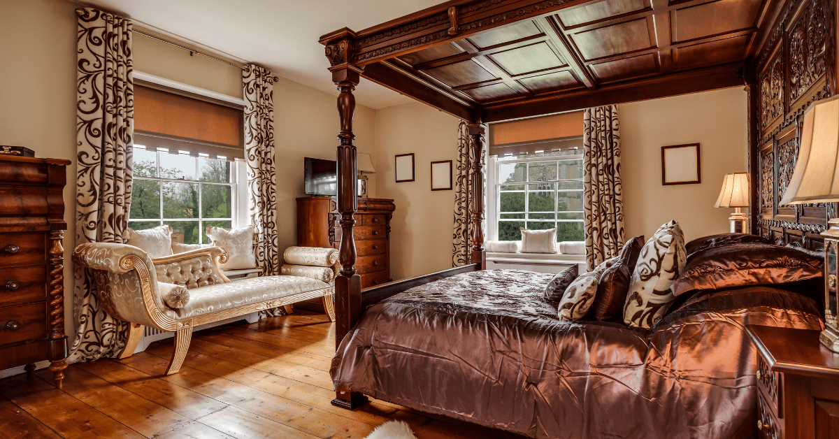 Luxurious small bedroom with a four poster bed.