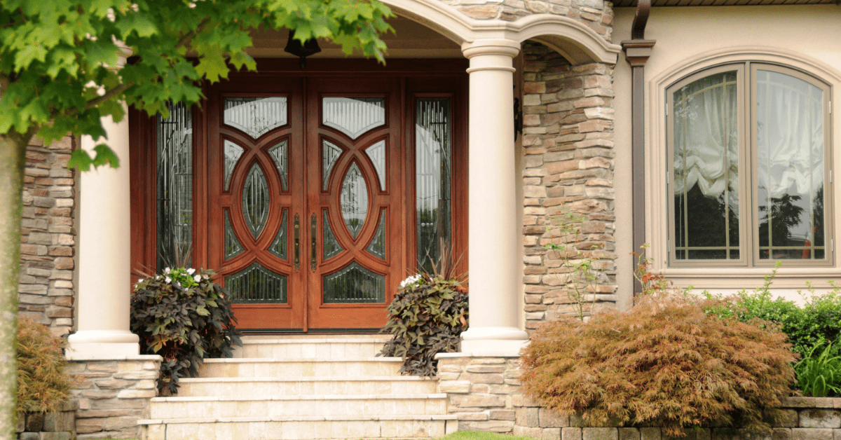 Front door with plants around it.