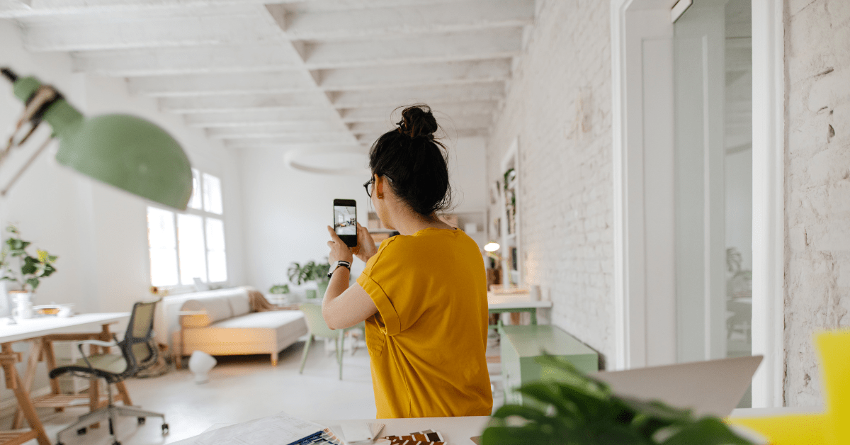 Girl taking picture of a room.