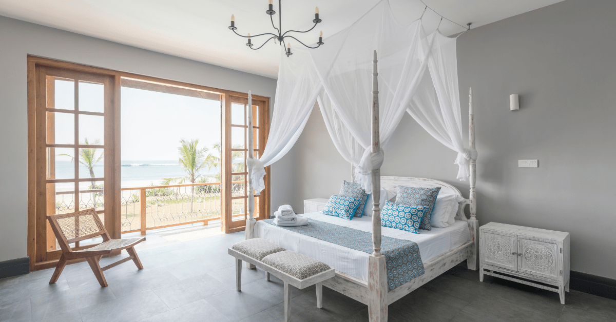 Airy bedroom with a four poster bed.