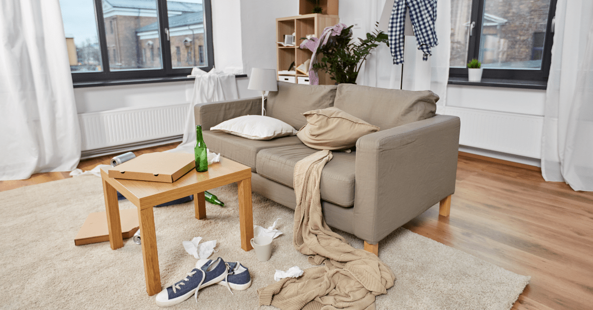 Clutter around the couch in a living room.