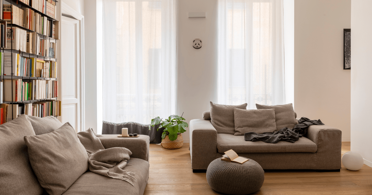 A cozy living room with bookshelves in the rear.