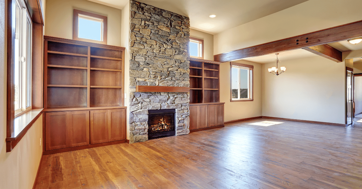 Empty room with stone fireplace.