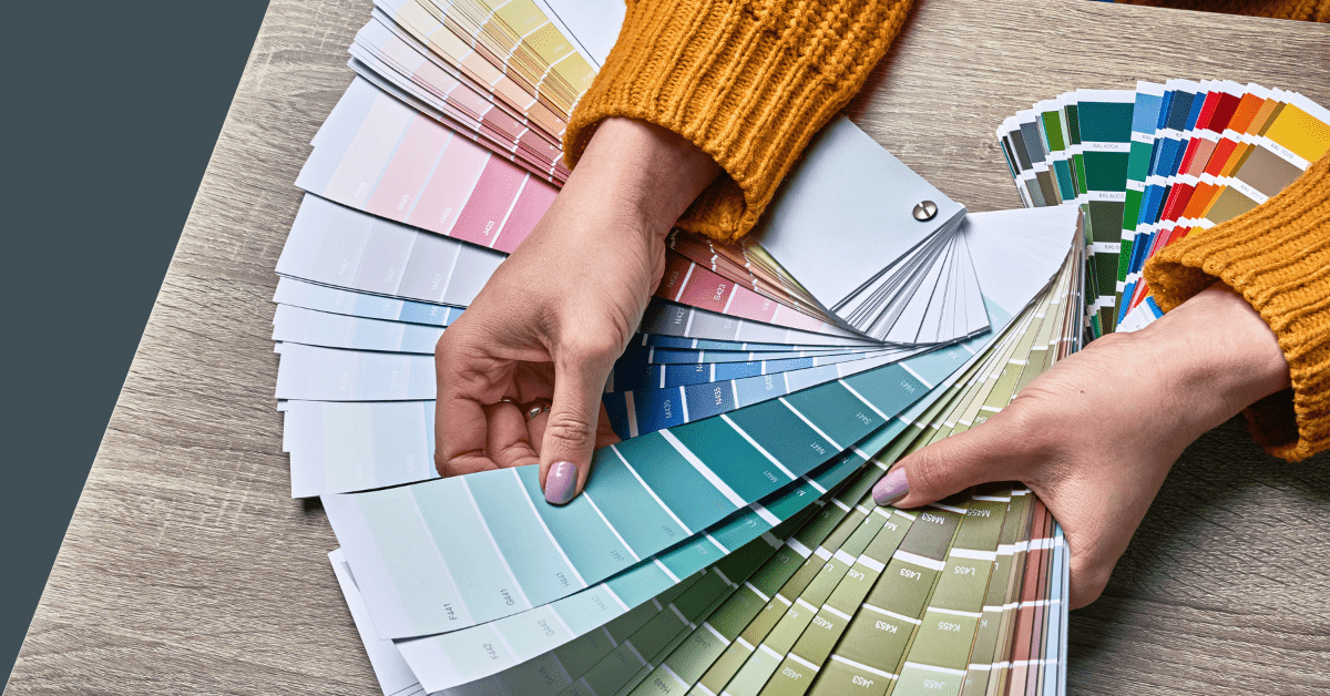 Person holding a selection of color palette.