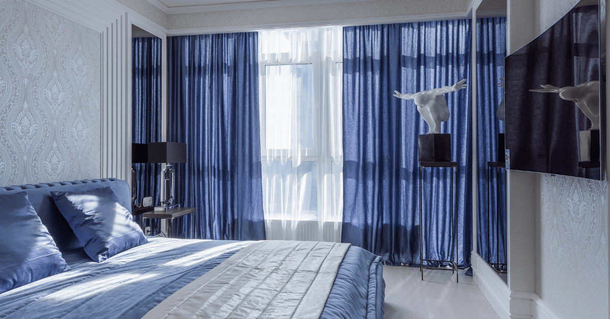 Blue bedroom with matching curtains.