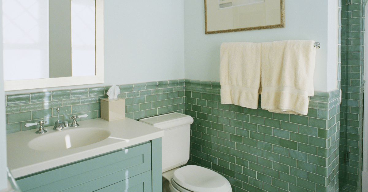 A bathroom with mint green finishes.