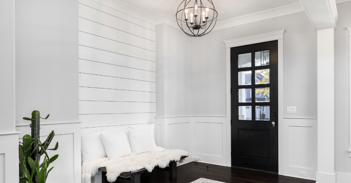 Blue entryway door with overhead lights.