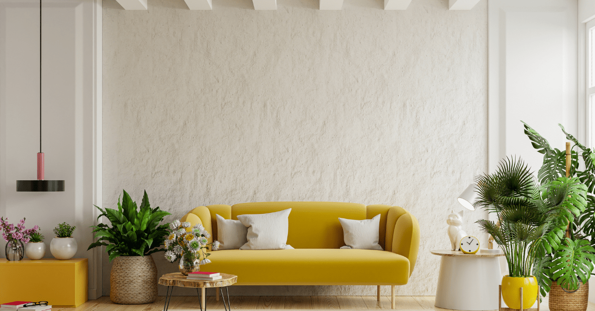 Yellow couch flanked by white wall.