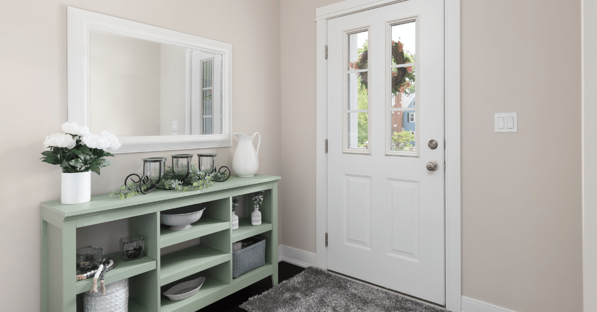 Green slim table in the entryway.