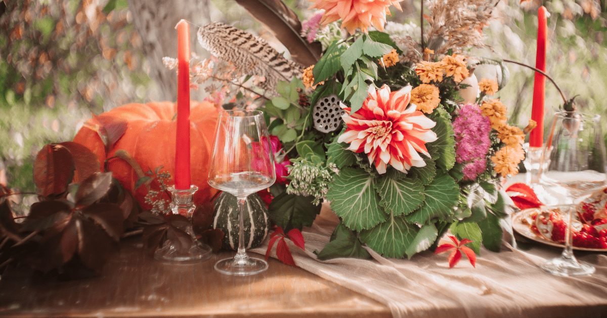 Table runner with fall decor on top.