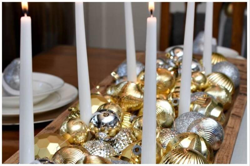 Silver and gold ornaments on table.