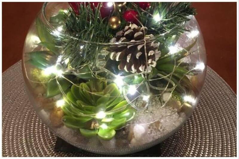 Glass bowl full of Christmas decor.