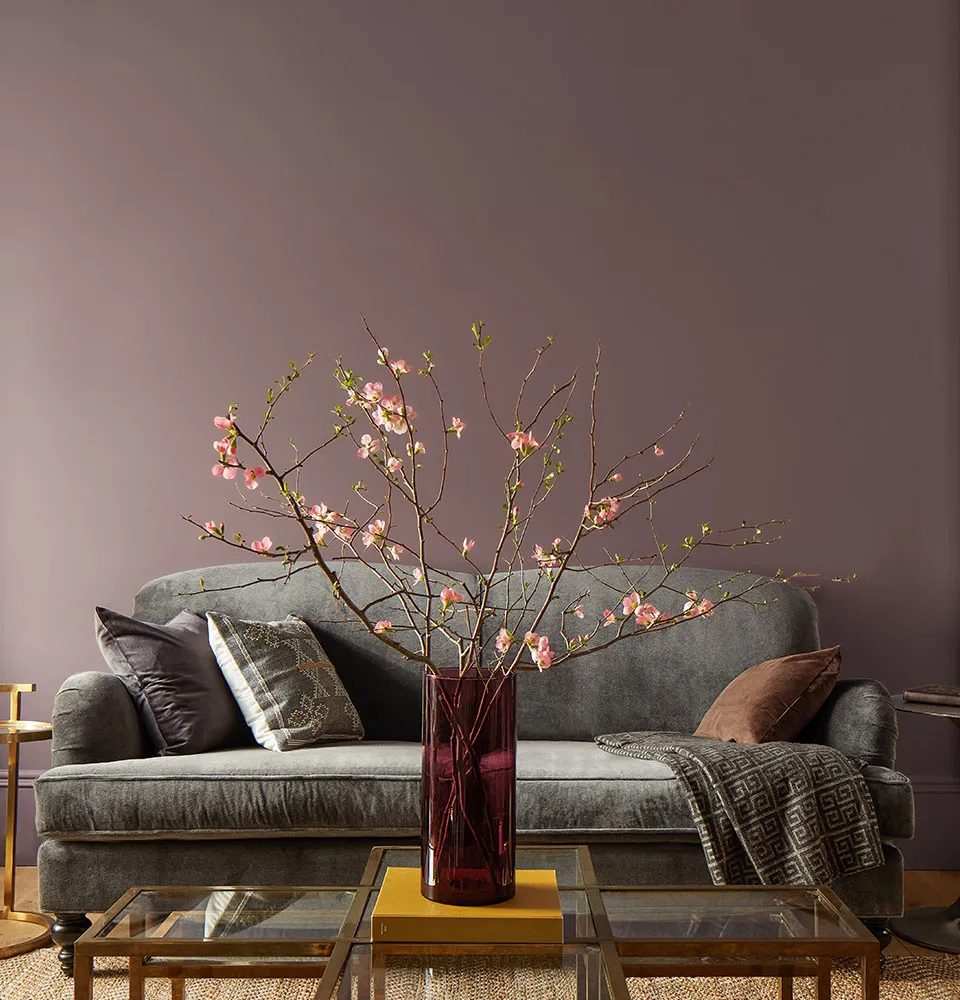 Couch flanked by a wall panted in Cinnamon Slate color.