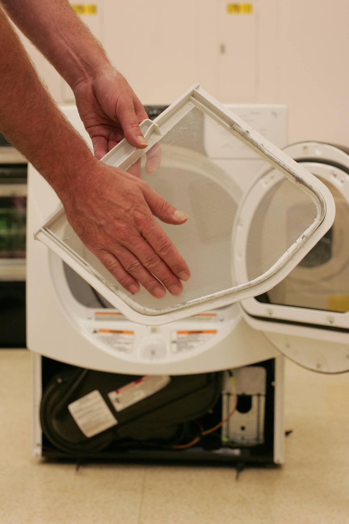 person cleaning out dryer lint