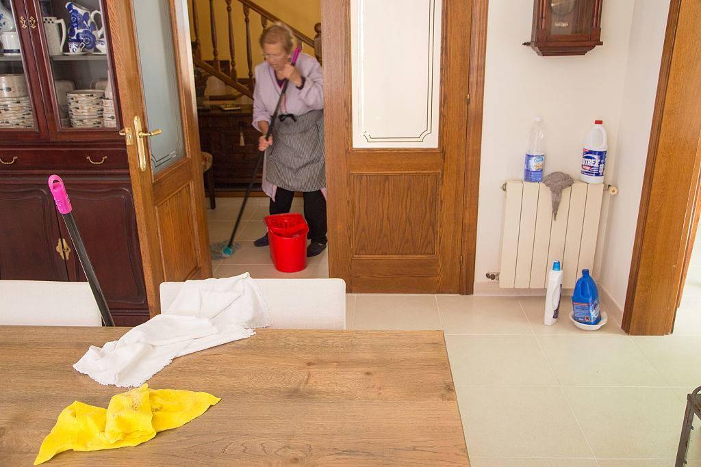 Older woman mopping hardwood floors