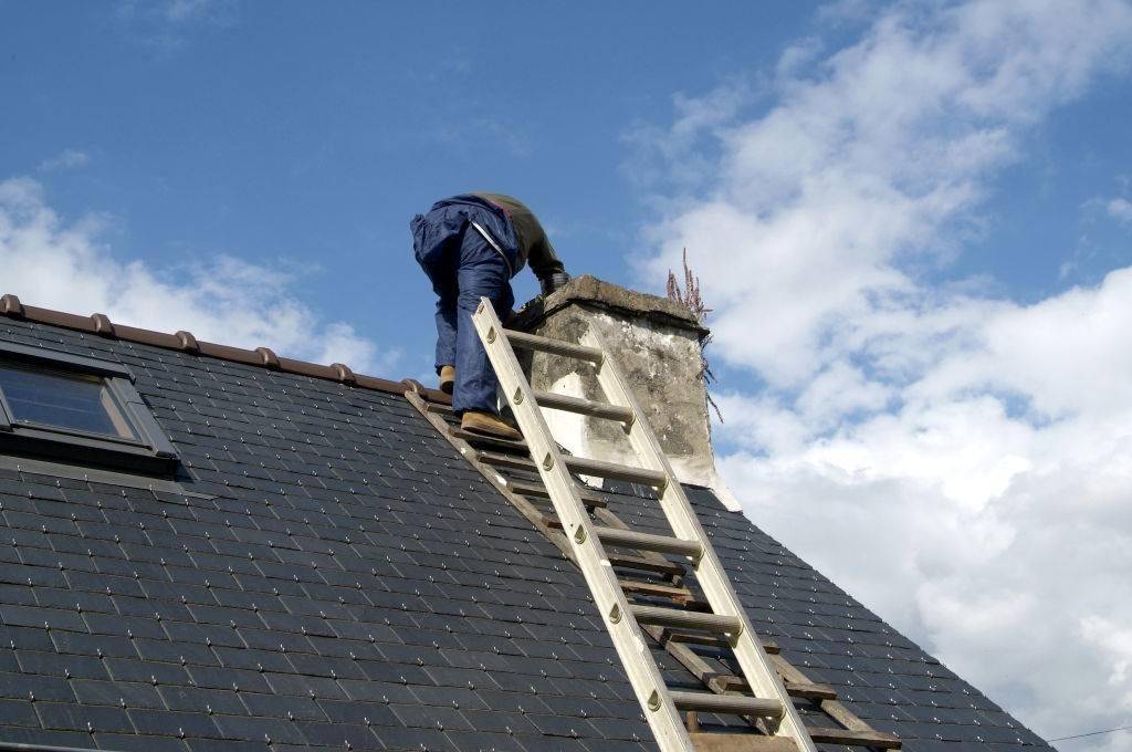 Man performing a chimney sweep