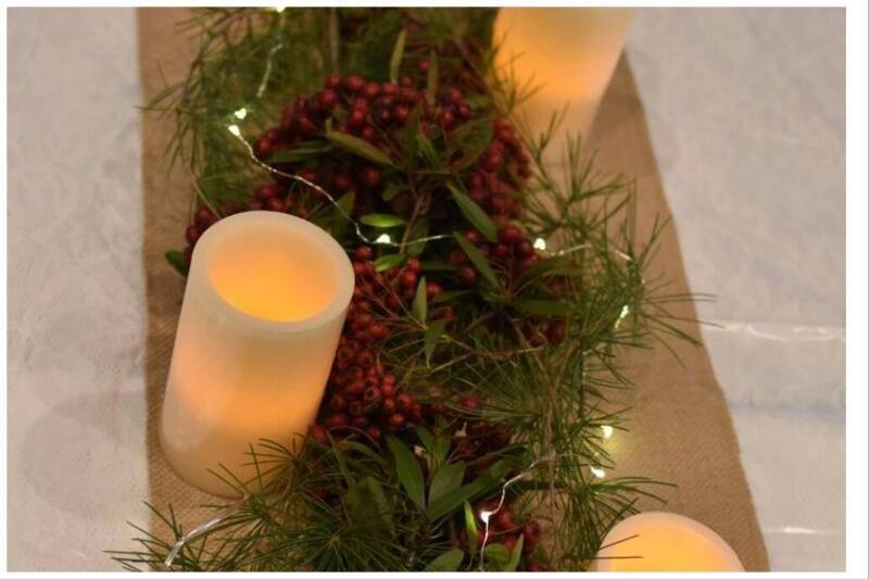 Candles lit up around table runner.