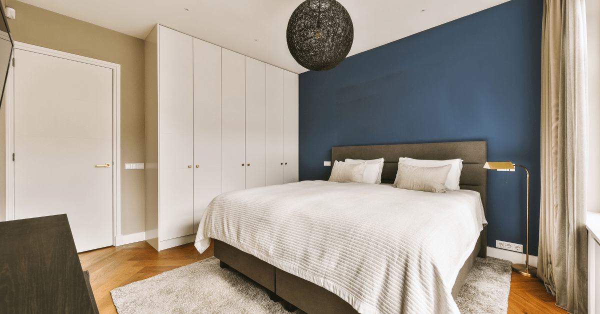 Bedroom with blue accent wall.