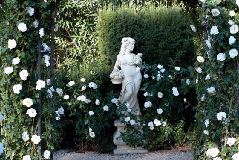 A statue and hydrangeas line hallelujah lane in Oprah's garden.