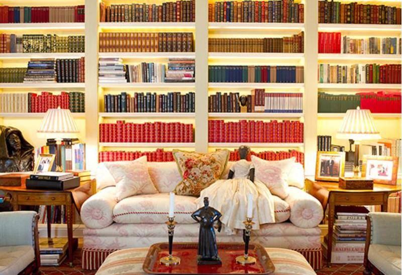 Shelves of books sit behind a couch in Oprah's library.