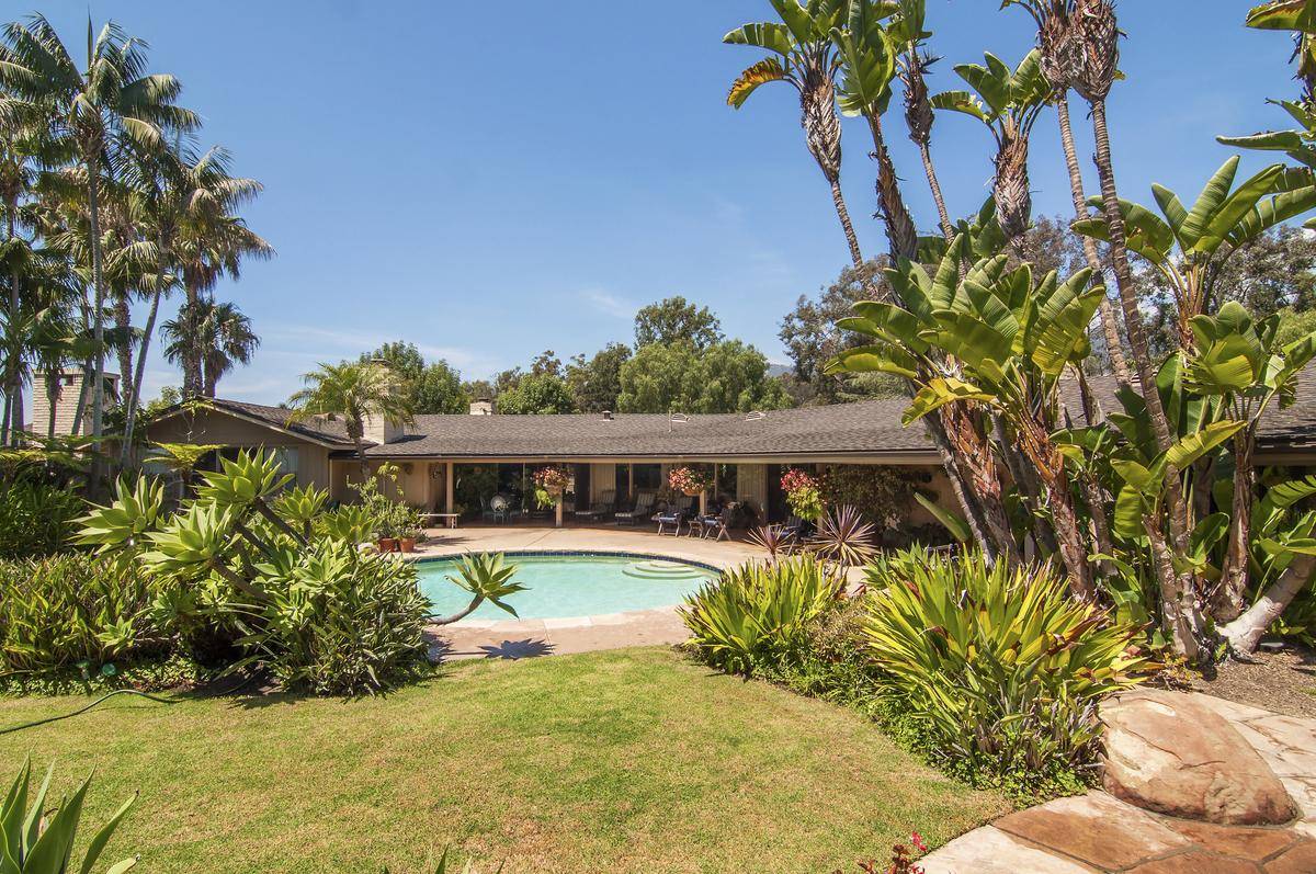 The backside of Oprah's house features her porch with the pool.