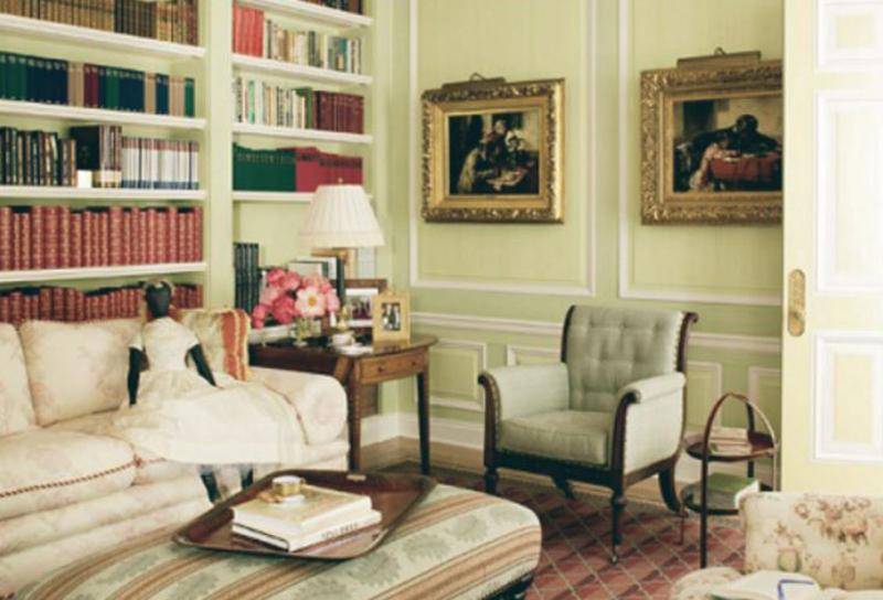 A view of Oprah's reading room features a couch, chair, and shelves full of books.