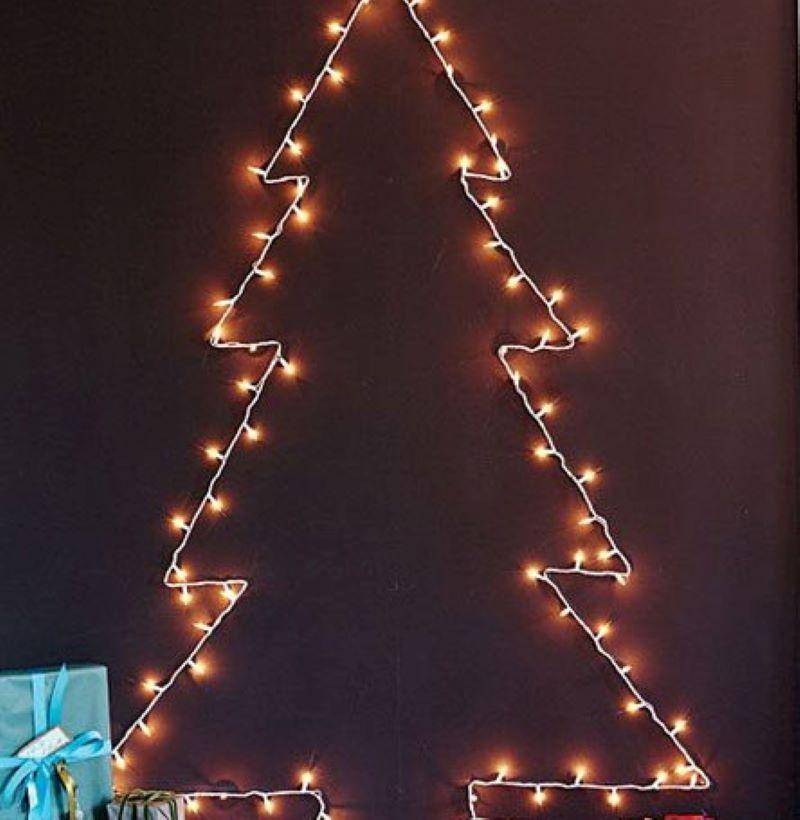 Christmas lights on wall in shape of a tree.