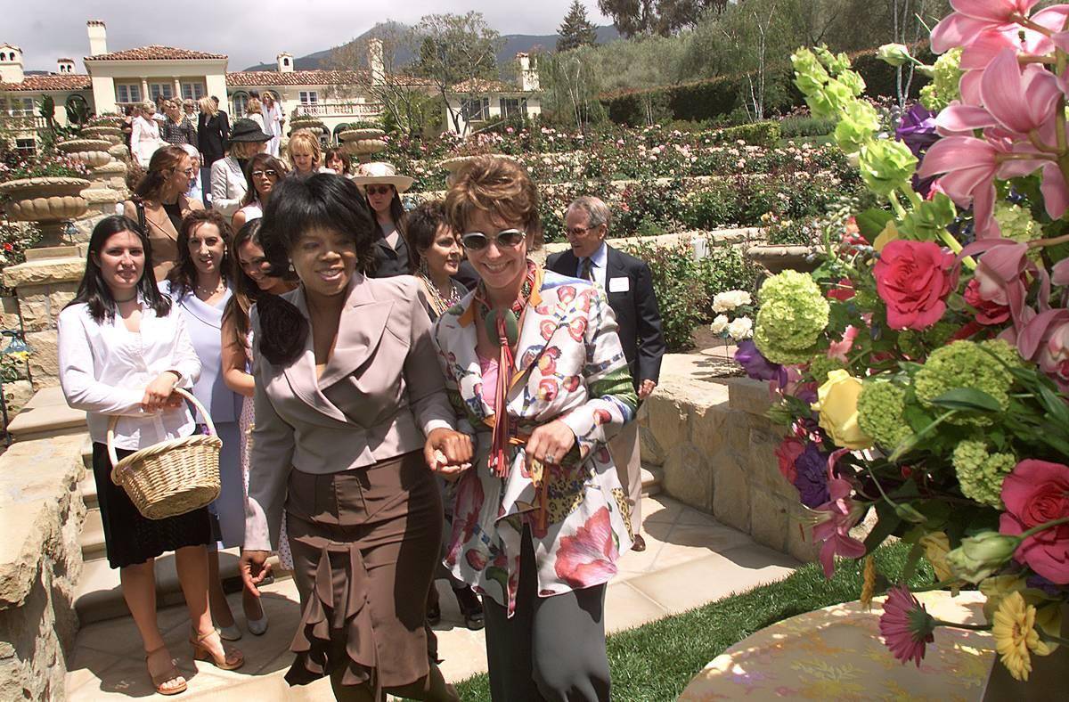 Oprah Winfrey, left, walks with Marlene Veloz, co-chair of Girls Inc. of Greater Santa Barbara