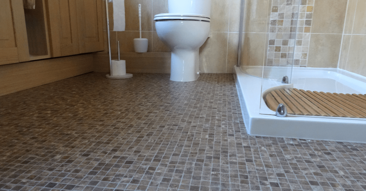 Bathroom with glass shower and mosaic tile.