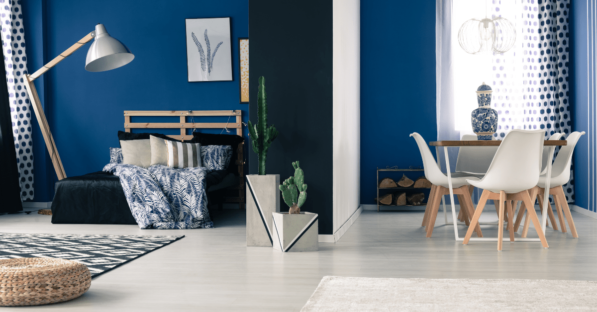 Bold blue living space with DIY bedframe.